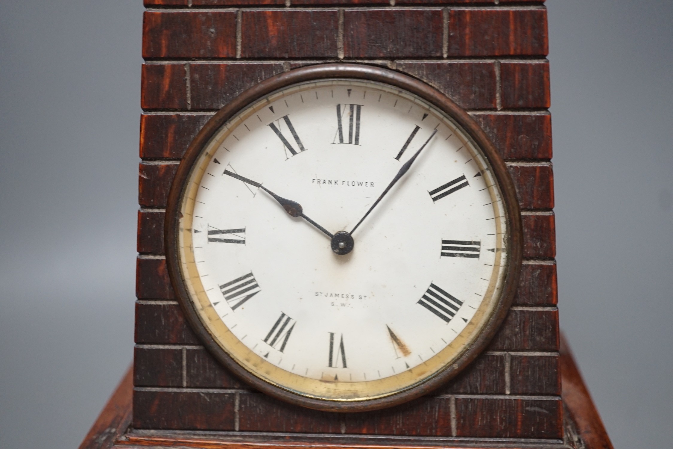 A late Victorian carved oak 'lighthouse' combined mantel timepiece and barometer, signed Frank Flower, St James' St, S.W, Height 53 cm